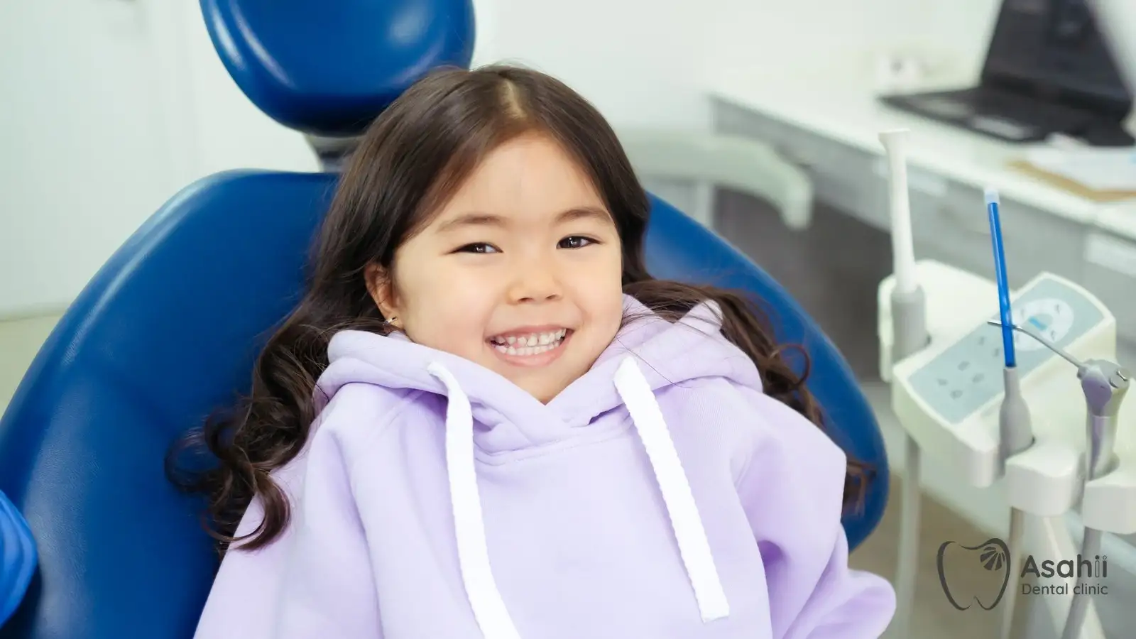 A happy child in the dental chair: regular check-ups catch decay in baby teeth early