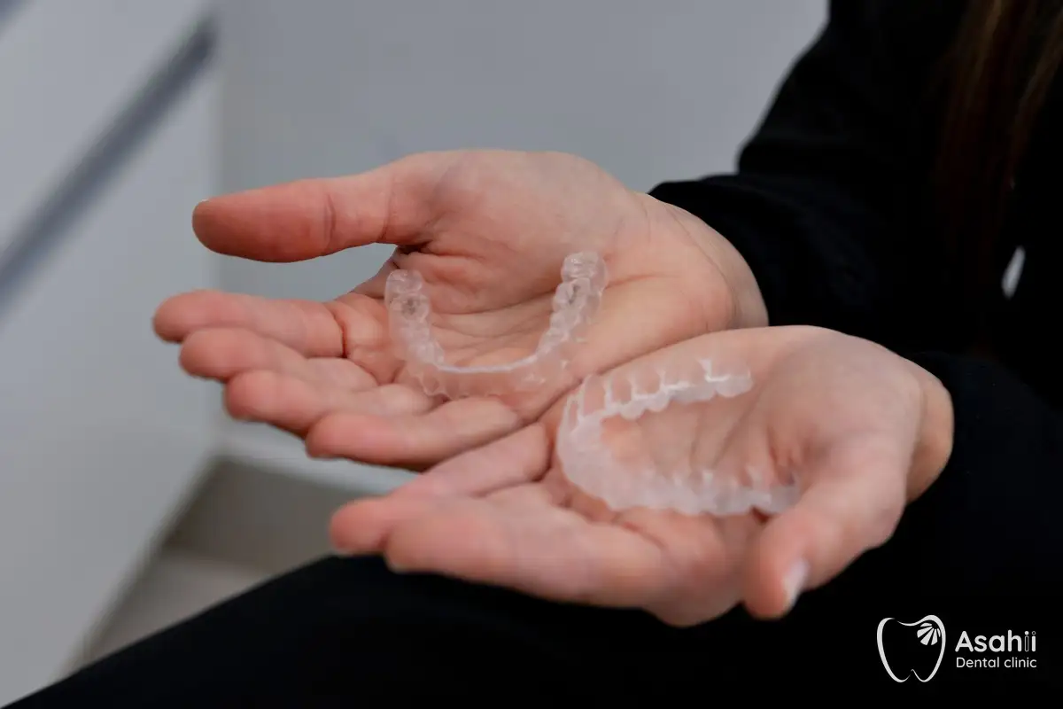 Two clear retainers: rinse them every day and keep them in their case when not worn