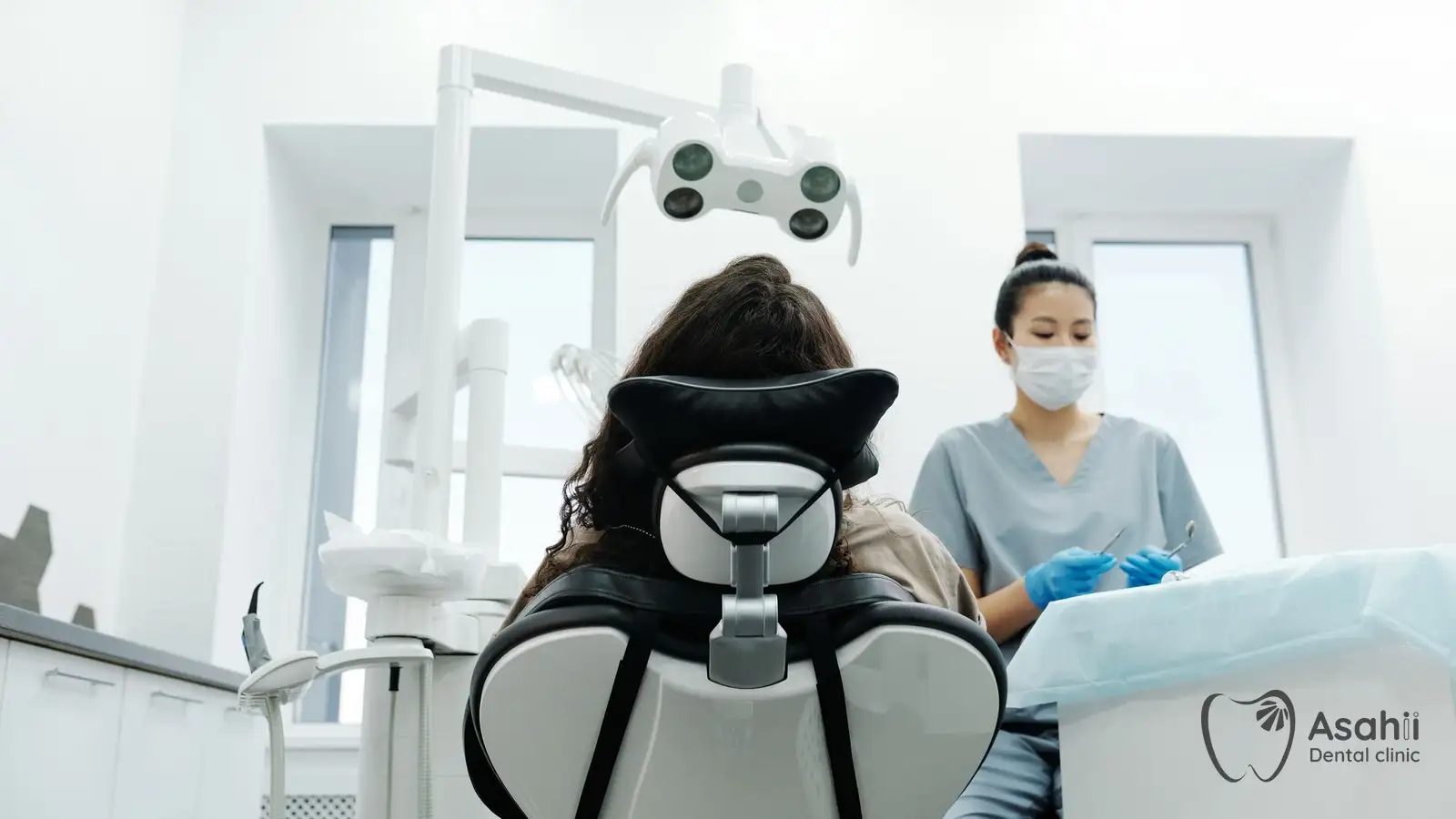 A dentist getting ready for a routine scale and clean, usually every six months