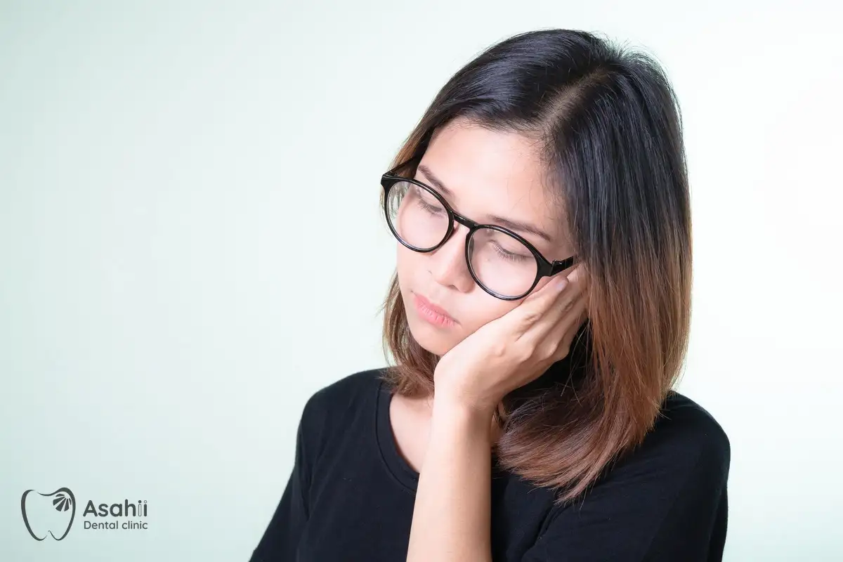 Holding a sore cheek: inflamed pulp from deep decay is the most common cause of toothache at night