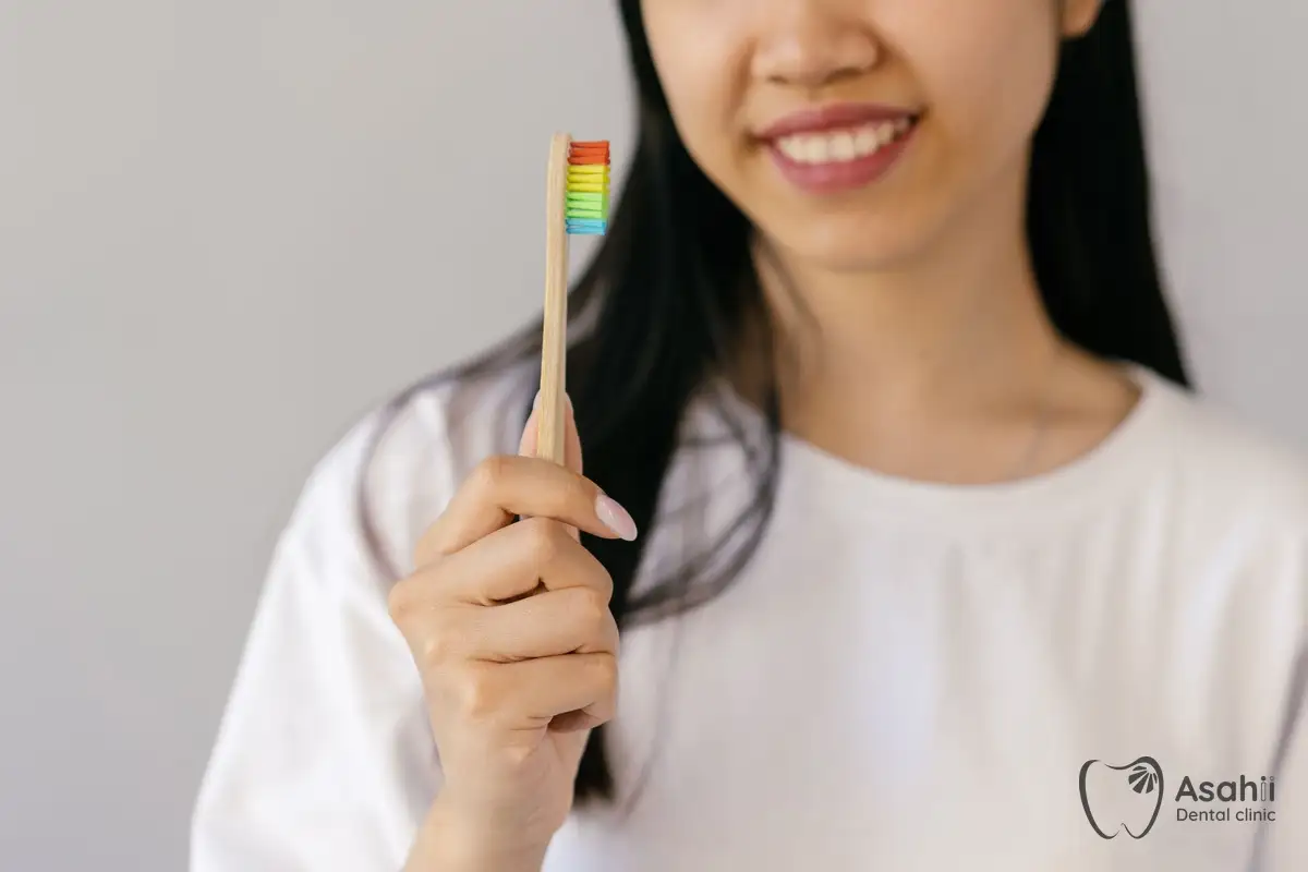 A soft-bristled toothbrush cleans gently around the implant without hurting the gums