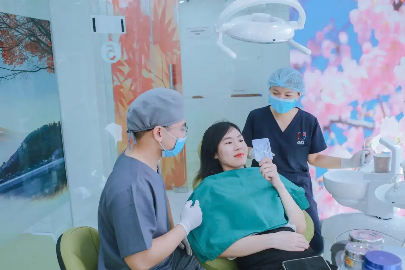 Bác sĩ và trợ thủ Asahii trao đổi với khách hàng trên ghế nha
